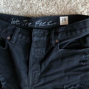Free People black denim shorts with button fly.